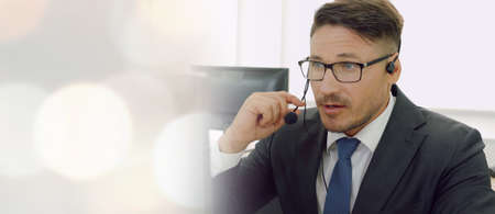 Business people wearing headset working in office to support remote customer or colleague. Call center, telemarketing, customer support agent provide service in broaden view .の写真素材