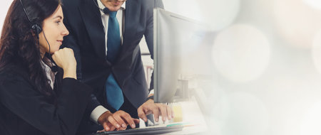 Business people wearing headset working in office to support remote customer or colleague. Call...
