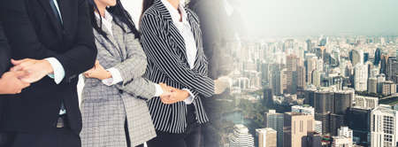 Successful business people standing together showing strong relationship of worker community. A team of businessman and businesswoman expressing a strong group teamwork at office broaden viewの写真素材