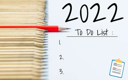 2022 Happy New Year Resolution Goal List and Plans Setting - Business office desk with notebook written about plan listing of new year goals and resolutions setting. Change and determination concept.の写真素材