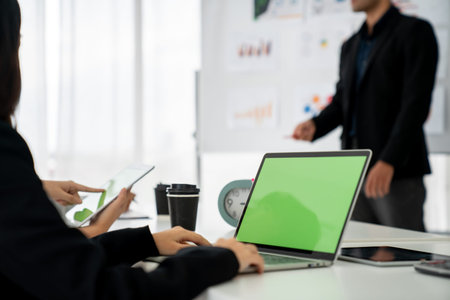 Businesswoman in business meeting using computer proficiently at office room . Corporate business...