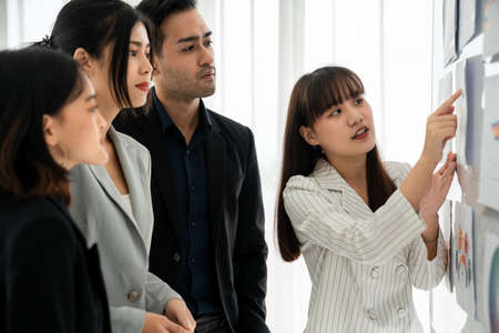 Business people proficiently discuss work project while sitting in circle . Corporate business team collaboration concept .の写真素材