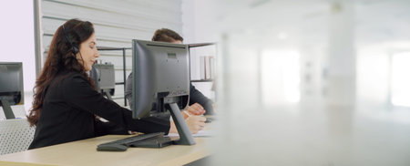 Business people wearing headset working in office to support remote customer or colleague. Call...