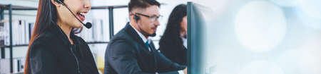 Call center or customer support agent in broaden view panoramic banner wearing headset while working at office to support remote customer or colleague on telephone video conference callの写真素材