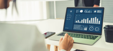 Businesswoman in business meeting using laptop computer proficiently at office for marketing data...