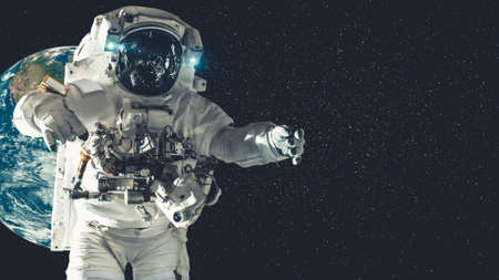 Astronaut spaceman do spacewalk while working for spaceflight mission at space station . Astronaut wear full spacesuit for operation .の写真素材