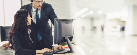 Business people wearing headset working in office to support remote customer or colleague. Call...