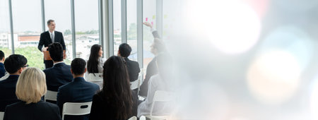 Group of business people meeting in a seminar conference widen view . Audience listening to instructor in employee education training session . Office worker community summit forum with speaker .の写真素材