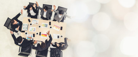 Successful business people celebrate together with joy at office table shot from top view . Young...