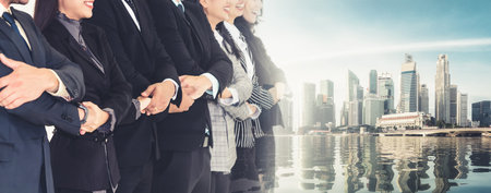 Successful business people standing together showing strong relationship of worker community. A team of businessman and businesswoman expressing a strong group teamwork at office broaden viewの写真素材