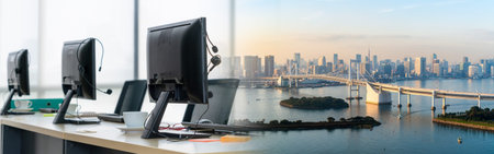 Call center computers and headsets all in office in widen view. Telemarketing, customer support...