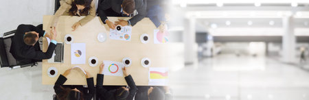 Business people group meeting shot from top view in office . Profession businesswomen, businessmen and office workers working in team conference with project planning document broaden view .の写真素材