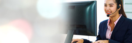 Business people wearing headset working in office in widen view to support remote customer or...