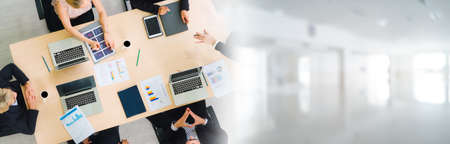 Business people group meeting shot from top widen view in office . Profession businesswomen, businessmen and office workers working in team conference with project planning document on meeting table .の写真素材