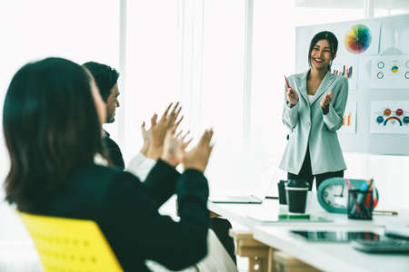 Businesswoman proficiently present work project receive celebrations from team . Corporate business team collaboration concept .の写真素材