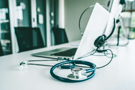 Headset and doctor equipment at clinic ready for actively support for patient by online video call . Concept of telehealth and telemedicine service .の写真素材
