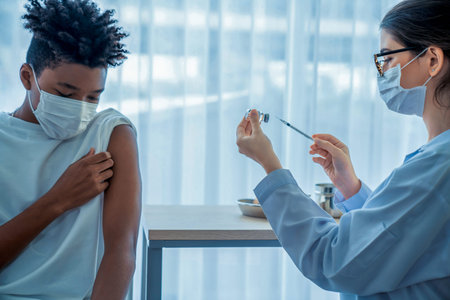 Young man visits skillful doctor at hospital for vaccination . Covid 19 and coronavirus vaccination...