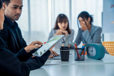 Business people proficiently discuss work project while sitting in circle . Corporate business team collaboration concept .の写真素材