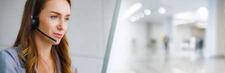 Business people wearing headset working in office in widen view to support remote customer or colleague. Call center, telemarketing, customer support agent provide service on telephone video call.の写真素材