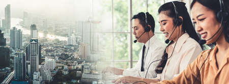 Business team wearing headset working actively in office . Call center, telemarketing, customer support agent provide service on telephone video conference call.の写真素材