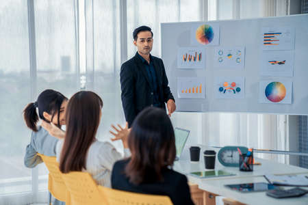 Business people proficiently discuss work project while sitting in circle . Corporate business team collaboration concept .の写真素材