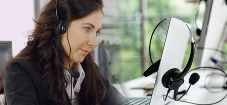 Business people wearing headset working in office to support remote customer or colleague. Call...