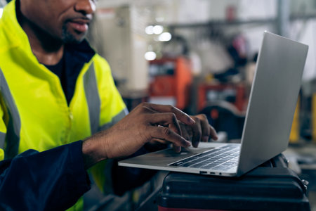 Factory worker working with laptop computer to do adept procedure checklist . Factory production line operator occupation quality control concept .の写真素材