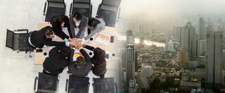 Happy business people celebrate teamwork success together with joy at office table shot from top...