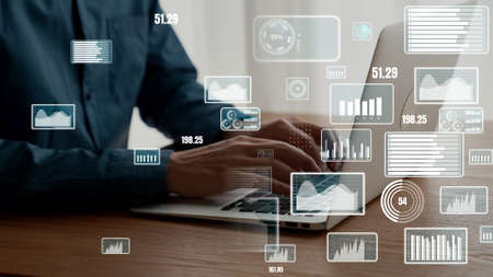 Businessman uses capable laptop computer to analyze business data analytic for marketing strategy and customer relationship managementの写真素材