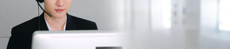 Business people wearing headset working in office in widen view to support remote customer or...