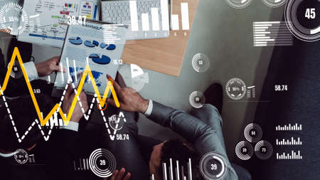 Conceptual vision of business people in corporate staff meeting . Concept of digital technology for marketing data analysis and investment decision making .の写真素材