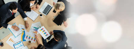 Business people group meeting shot from top widen view in office . Profession businesswomen, businessmen and office workers working in team conference with project planning document on meeting table .の写真素材