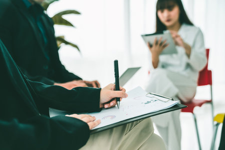 Business people proficiently discuss work project while sitting in circle . Corporate business team collaboration concept .の写真素材