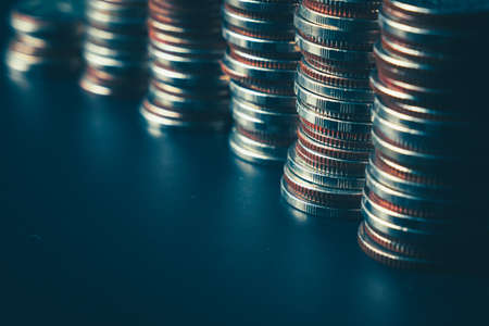 Pile of gold coins stack in finance treasury deposit bank account for saving . Concept of corporate business economy and financial growth by investment in valuable asset to gain cash revenue profit .の写真素材