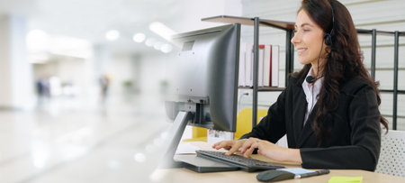 Business people wearing headset working in office to support remote customer or colleague. Call center, telemarketing, customer support agent provide service in broaden view .の写真素材