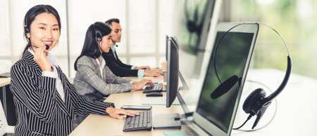 Business people wearing headset working in office to support remote customer or colleague. Call...