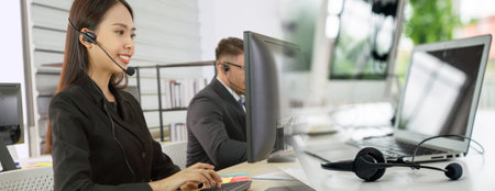 Business people wearing headset working in office to support remote customer or colleague. Call...