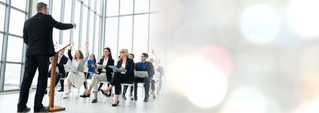 Group of business people meeting in a seminar conference widen view . Audience listening to instructor in employee education training session . Office worker community summit forum with speaker .の写真素材