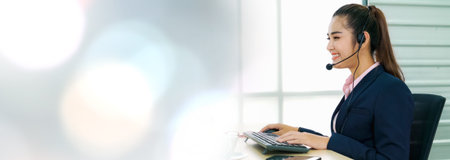 Business people wearing headset working in office in widen view to support remote customer or...