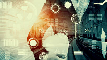 Future building construction and inventive engineering project concept with HUD hologram graphic design. Building engineer, architect people or construction worker works with modern civil technology.の写真素材