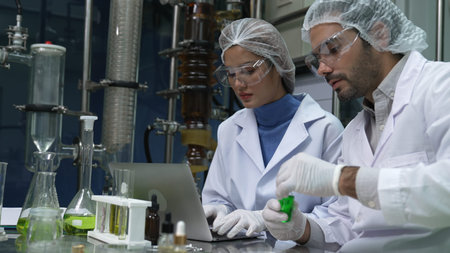 Two scientist in professional uniform working in laboratory for chemical and biomedical experiment