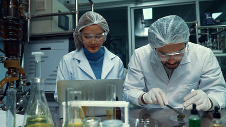 Two scientist in professional uniform working in laboratory for chemical and biomedical experiment