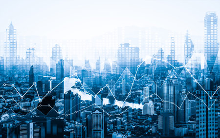 As background for a financial or business concept, digital screen and financial graphs overlap on a...