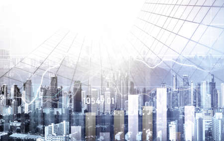 As background for a financial or business concept, digital screen and financial graphs overlap on a picture of modernistic cityscape, skyscrabbers.の写真素材