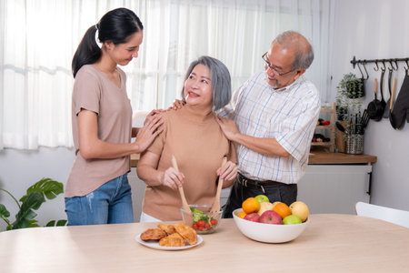 Contented family, daughter, father, mother prepare bread veggies and fruit salad together in their...