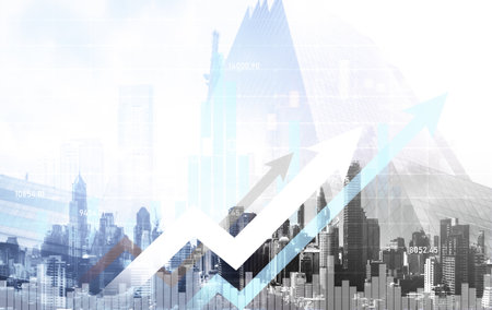 As background for a financial or business concept, digital screen and financial graphs overlap on a picture of modernistic cityscape, skyscrabbers.の写真素材