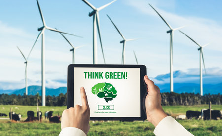Green business transformation for environment saving and ESG business concept. Businessman using tablet to set corporate goal toward environmental friendly management and alternative clean energy use.の写真素材