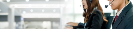 Business people wearing headset working in office in widen view to support remote customer or...