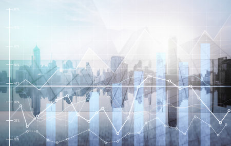 As background for a financial or business concept, digital screen and financial graphs overlap on a picture of modernistic cityscape, skyscrabbers.の写真素材