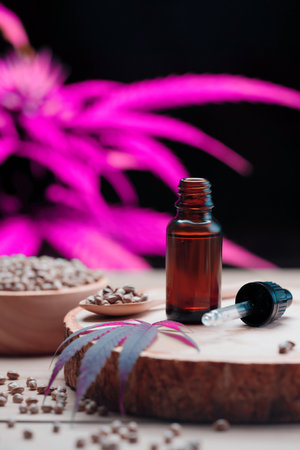 Set of legalized cannabis products features with CBD oil, hemp seeds in a wooden bowl, and a spoon. Concept of cannabis for medical and healthcare purpose.の写真素材